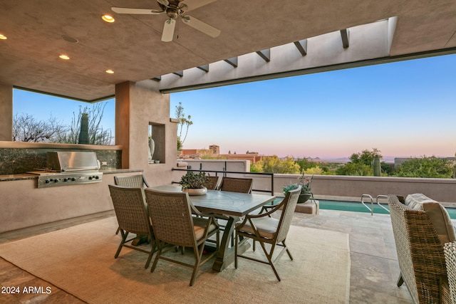 patio terrace at dusk featuring a fenced in pool, area for grilling, and ceiling fan