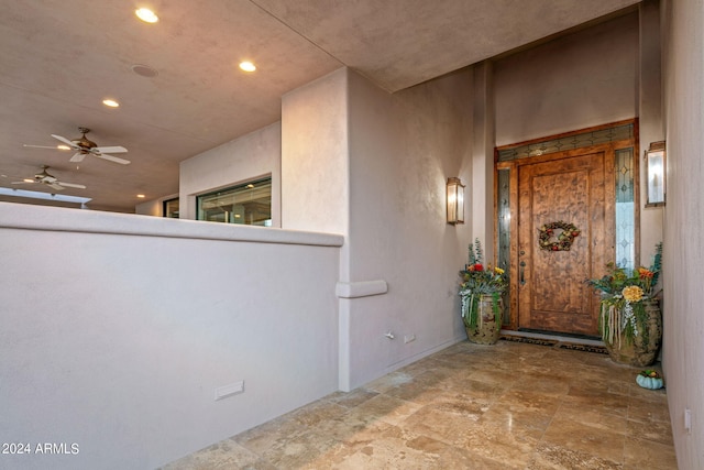 entrance to property with ceiling fan