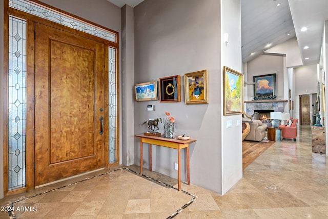 entrance foyer featuring high vaulted ceiling