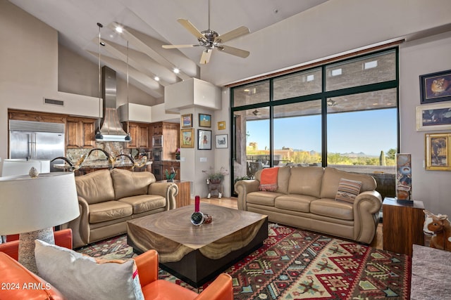 living room featuring ceiling fan and high vaulted ceiling