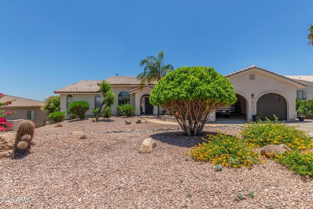 15513 E Palisades Blvd, Fountain Hills, AZ 85268 - mediterranean / spanish home featuring stucco siding, an attached garage, a tile roof, and driveway