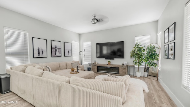 3103 S Benton, Mesa, AZ 85212 - living area featuring light wood-style floors, baseboards, and a glass covered fireplace