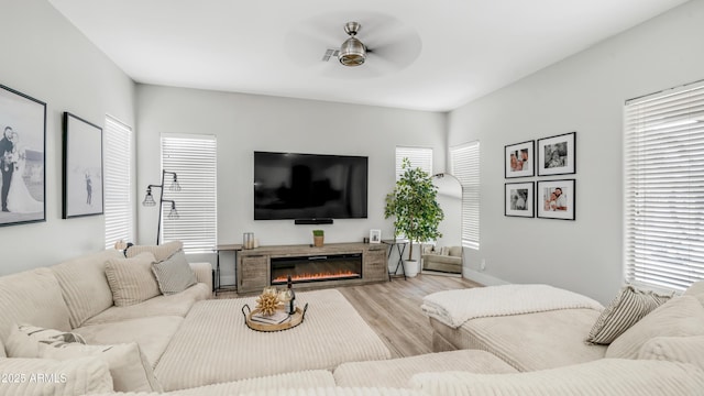 3103 S Benton, Mesa, AZ 85212 - living area with ceiling fan, wood finished floors, a glass covered fireplace, and baseboards