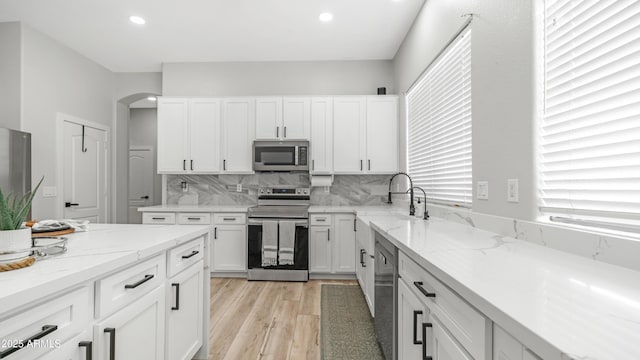 3103 S Benton, Mesa, AZ 85212 - kitchen featuring appliances with stainless steel finishes, a sink, arched walkways, white cabinetry, and recessed lighting