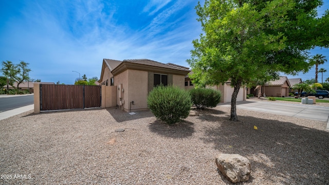3103 S Benton, Mesa, AZ 85212 - view of front of home with stucco siding, a gate, a tiled roof, concrete driveway, and a garage