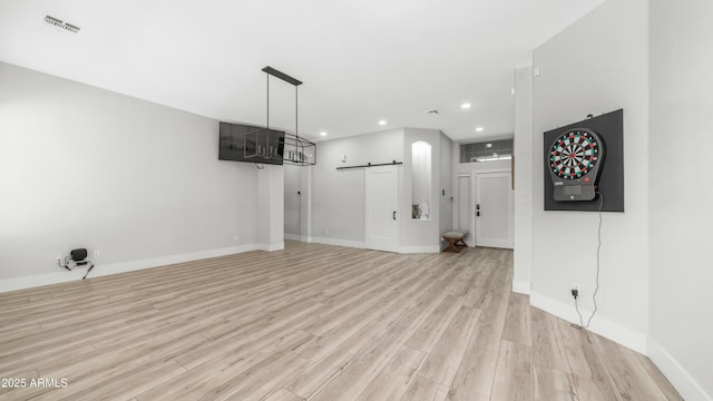 3103 S Benton, Mesa, AZ 85212 - unfurnished living room with a barn door, recessed lighting, light wood-style flooring, and baseboards