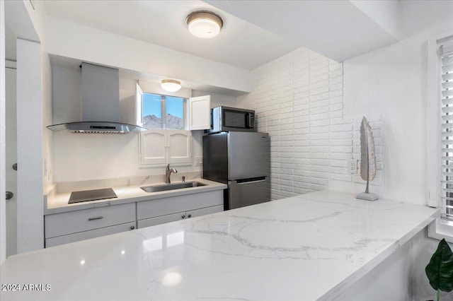 kitchen featuring decorative backsplash, white cabinetry, sink, wall chimney exhaust hood, and stainless steel appliances