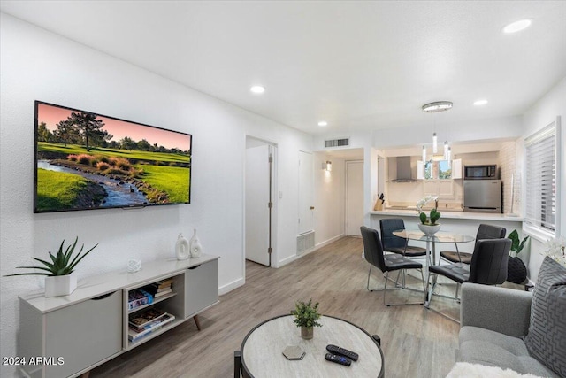 living room featuring light hardwood / wood-style flooring and a chandelier