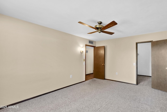 unfurnished bedroom featuring carpet floors, visible vents, ceiling fan, and baseboards