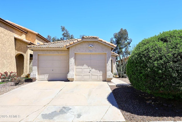 3122 E Kristal Way, Phoenix, AZ 85050 - view of side of property with stucco siding, concrete driveway, a garage, and a tile roof