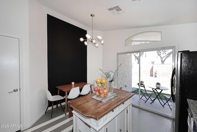 3122 E Kristal Way, Phoenix, AZ 85050 - dining space with a chandelier and concrete flooring