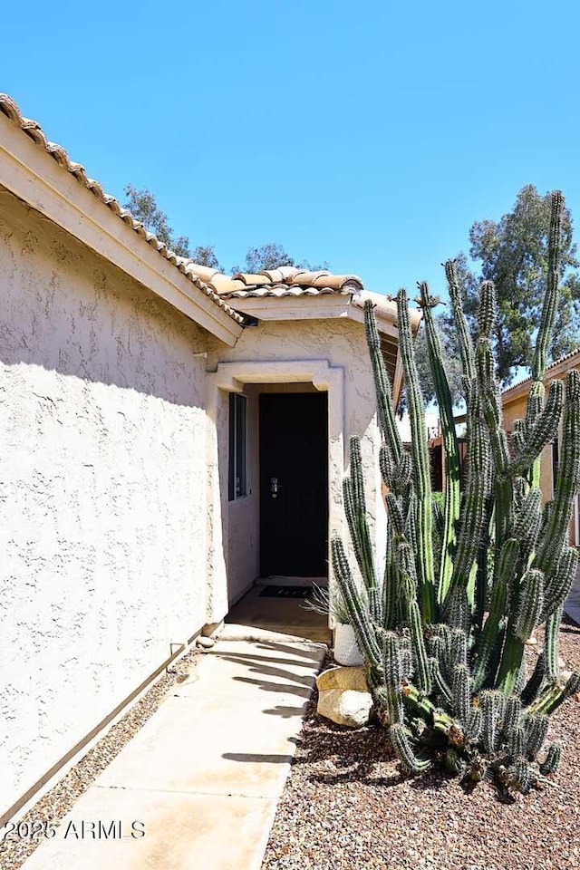 3122 E Kristal Way, Phoenix, AZ 85050 - view of exterior entry featuring stucco siding and a tile roof