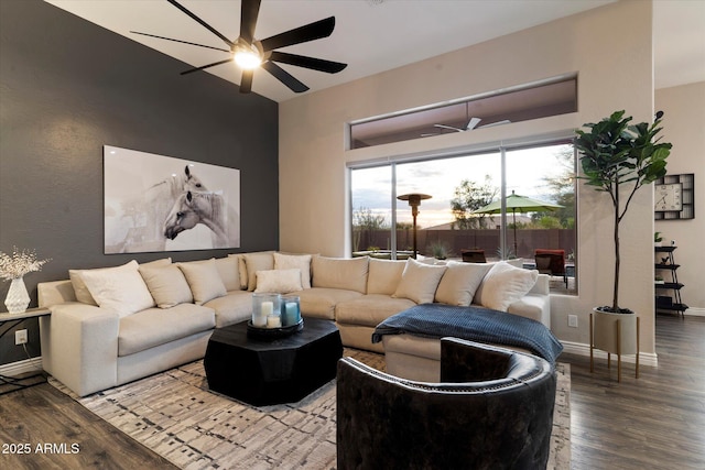 living room featuring hardwood / wood-style floors and ceiling fan