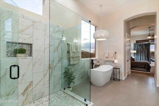 bathroom with independent shower and bath, ceiling fan, and tile patterned floors