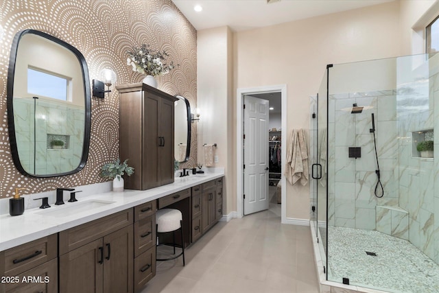 bathroom with walk in shower and vanity