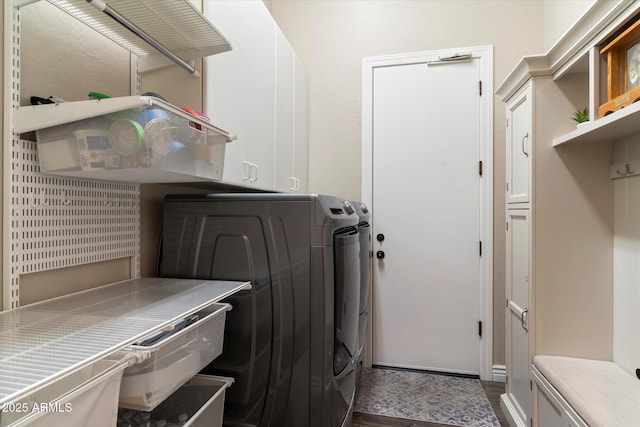 laundry room with dark hardwood / wood-style flooring, cabinets, and washer and dryer