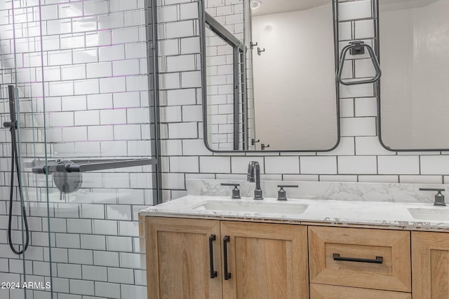 bathroom featuring vanity and tiled shower