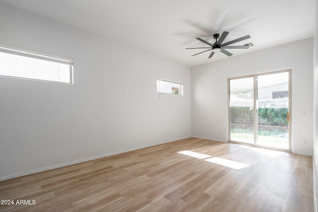 spare room with ceiling fan, a healthy amount of sunlight, and light hardwood / wood-style floors