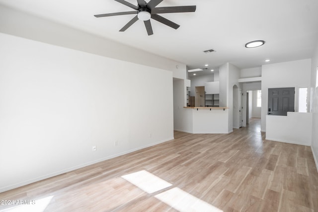 unfurnished living room featuring light hardwood / wood-style flooring and ceiling fan