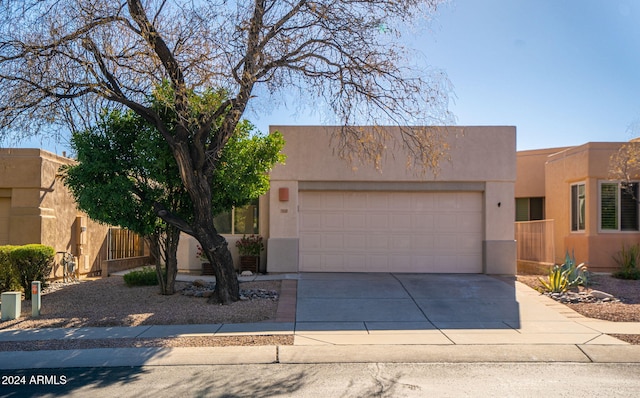 pueblo-style home featuring a garage