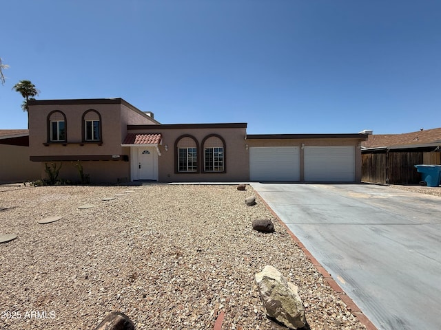 3145 W Acoma Dr, Phoenix, AZ 85053 - mediterranean / spanish-style home featuring an attached garage, concrete driveway, and stucco siding
