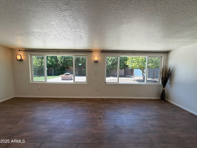 3145 W Acoma Dr, Phoenix, AZ 85053 - unfurnished room with dark wood-type flooring and a textured ceiling