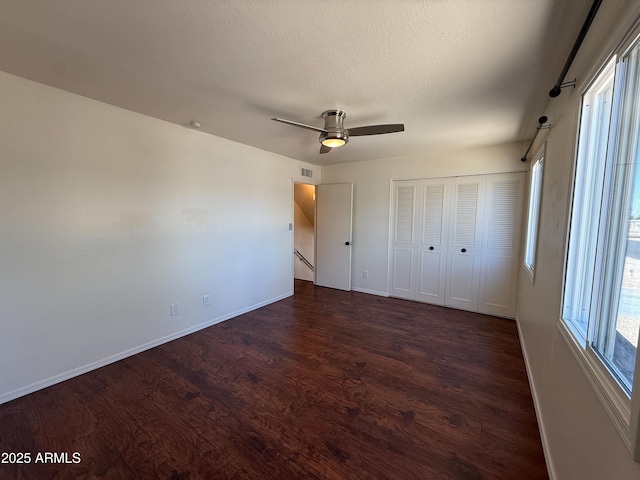 3145 W Acoma Dr, Phoenix, AZ 85053 - unfurnished bedroom featuring dark wood finished floors, a ceiling fan, a textured ceiling, and a closet