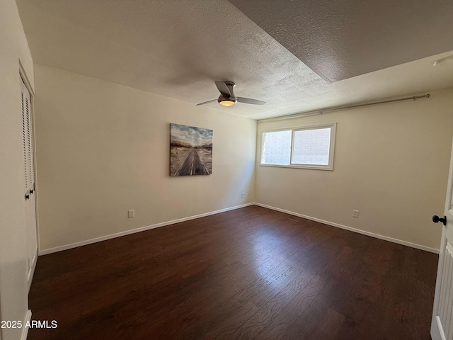 3145 W Acoma Dr, Phoenix, AZ 85053 - spare room featuring a ceiling fan, dark wood-type flooring, and a textured ceiling
