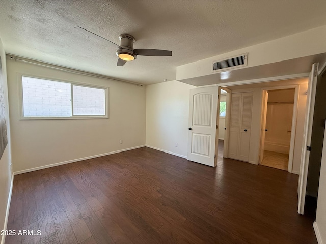 3145 W Acoma Dr, Phoenix, AZ 85053 - unfurnished bedroom with a textured ceiling, dark wood-style flooring, and a ceiling fan