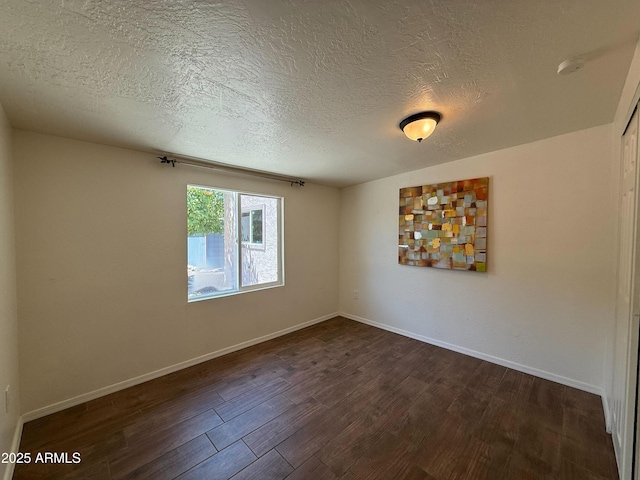 3145 W Acoma Dr, Phoenix, AZ 85053 - unfurnished room with dark wood-style flooring and a textured ceiling