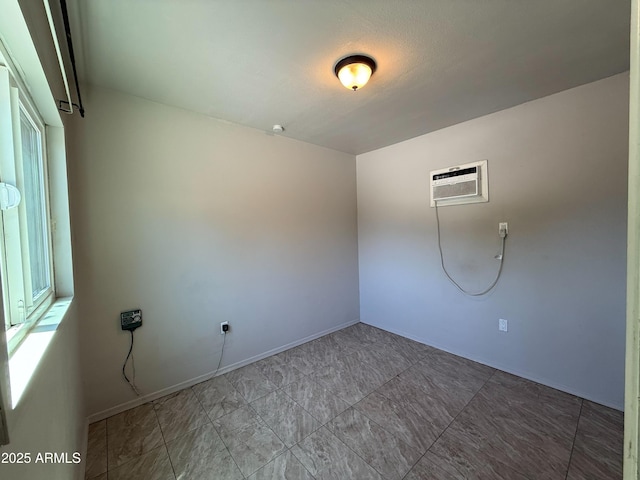 3145 W Acoma Dr, Phoenix, AZ 85053 - spare room with a wall mounted AC and baseboards