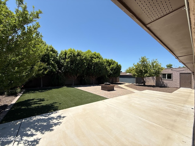 3145 W Acoma Dr, Phoenix, AZ 85053 - view of patio / terrace with a fire pit and a storage unit
