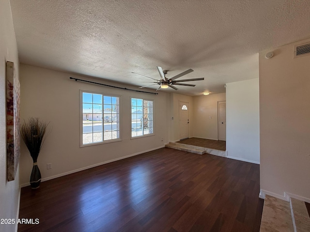 3145 W Acoma Dr, Phoenix, AZ 85053 - unfurnished room with a textured ceiling, dark wood finished floors, and a ceiling fan