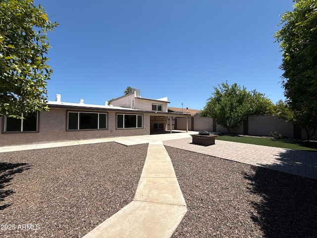 3145 W Acoma Dr, Phoenix, AZ 85053 - back of property with an outdoor fire pit, a patio, a fenced backyard, and stucco siding