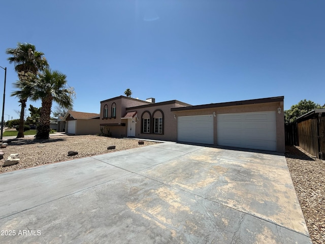 3145 W Acoma Dr, Phoenix, AZ 85053 - mediterranean / spanish house with stucco siding, driveway, and an attached garage