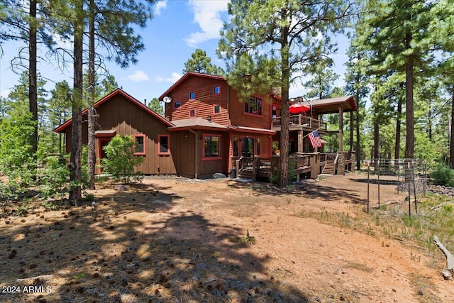 back of house with a deck