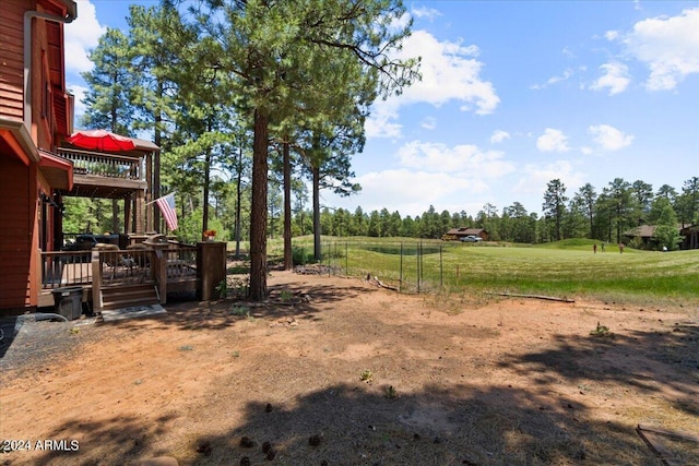 view of yard featuring a deck and stairs