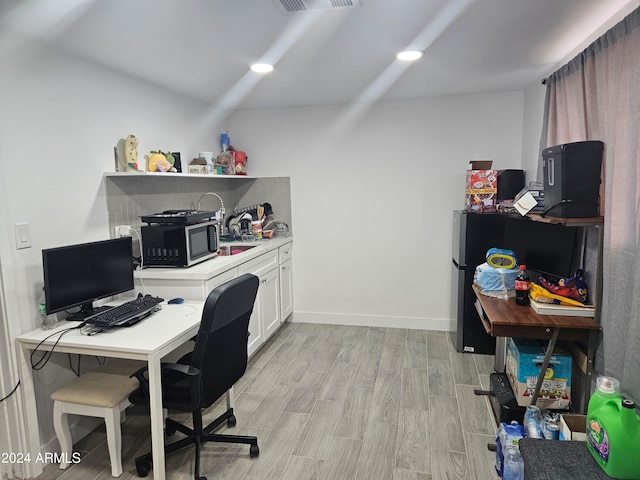 office space with light hardwood / wood-style floors