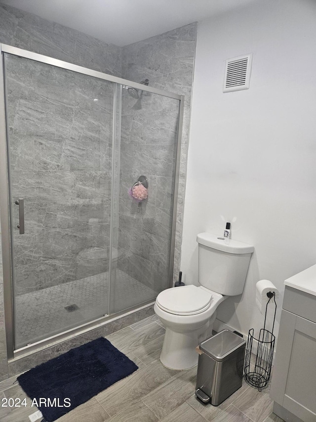 bathroom featuring an enclosed shower and toilet