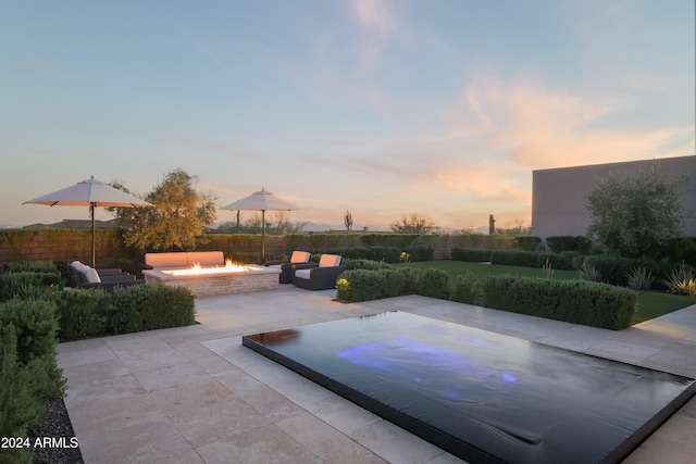 patio terrace at dusk with an outdoor fire pit