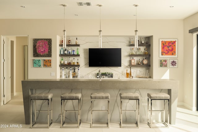 bar with decorative light fixtures and light tile patterned flooring