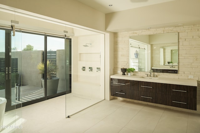 bathroom with tile patterned floors, a shower, and vanity