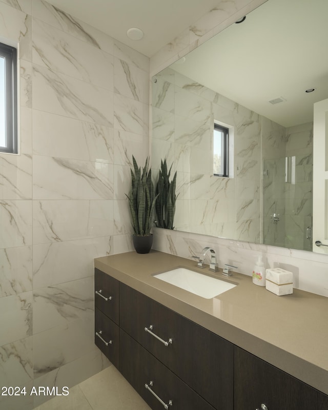 bathroom with vanity, walk in shower, and tile walls