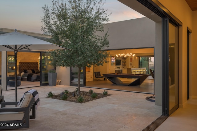 patio terrace at dusk featuring outdoor lounge area