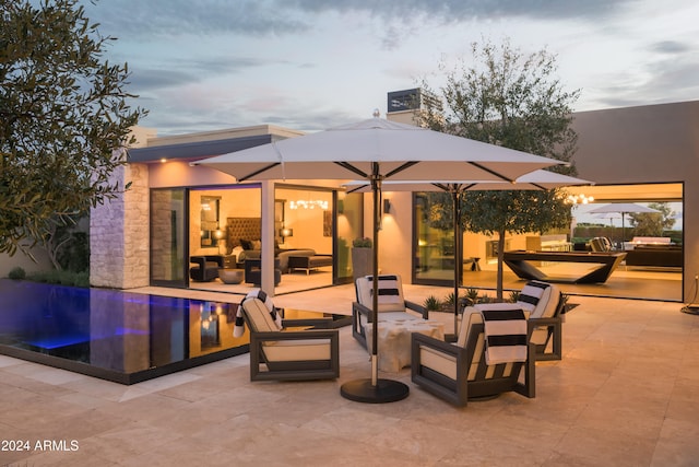 patio terrace at dusk with an outdoor living space