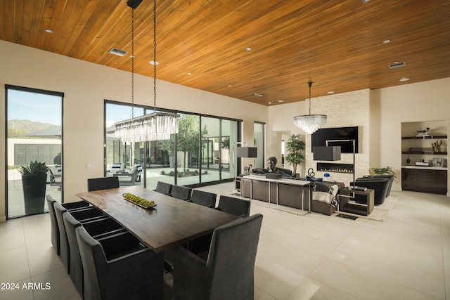 dining room featuring a mountain view, a notable chandelier, and wood ceiling