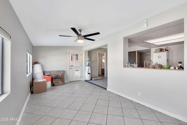 tiled spare room with ceiling fan