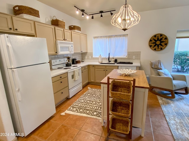 kitchen with sink, backsplash, pendant lighting, white appliances, and light tile patterned floors