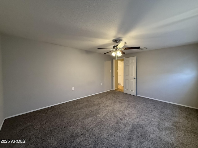 carpeted spare room featuring visible vents, baseboards, and a ceiling fan