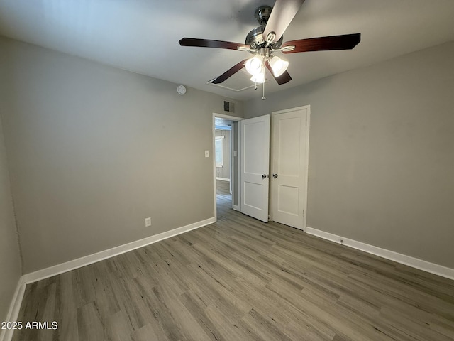 unfurnished room featuring visible vents, baseboards, a ceiling fan, and wood finished floors